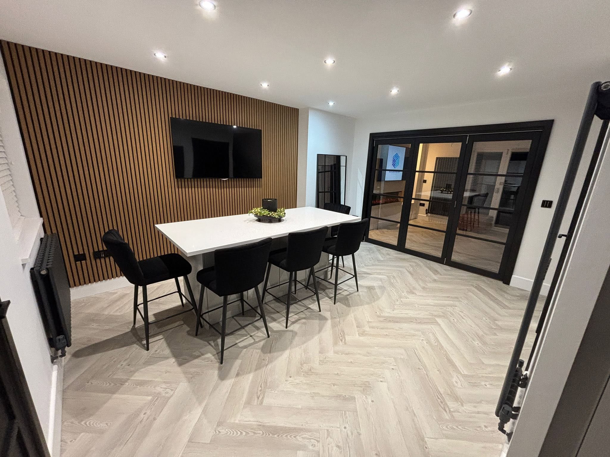 Contemporary dining space with slat feature wall