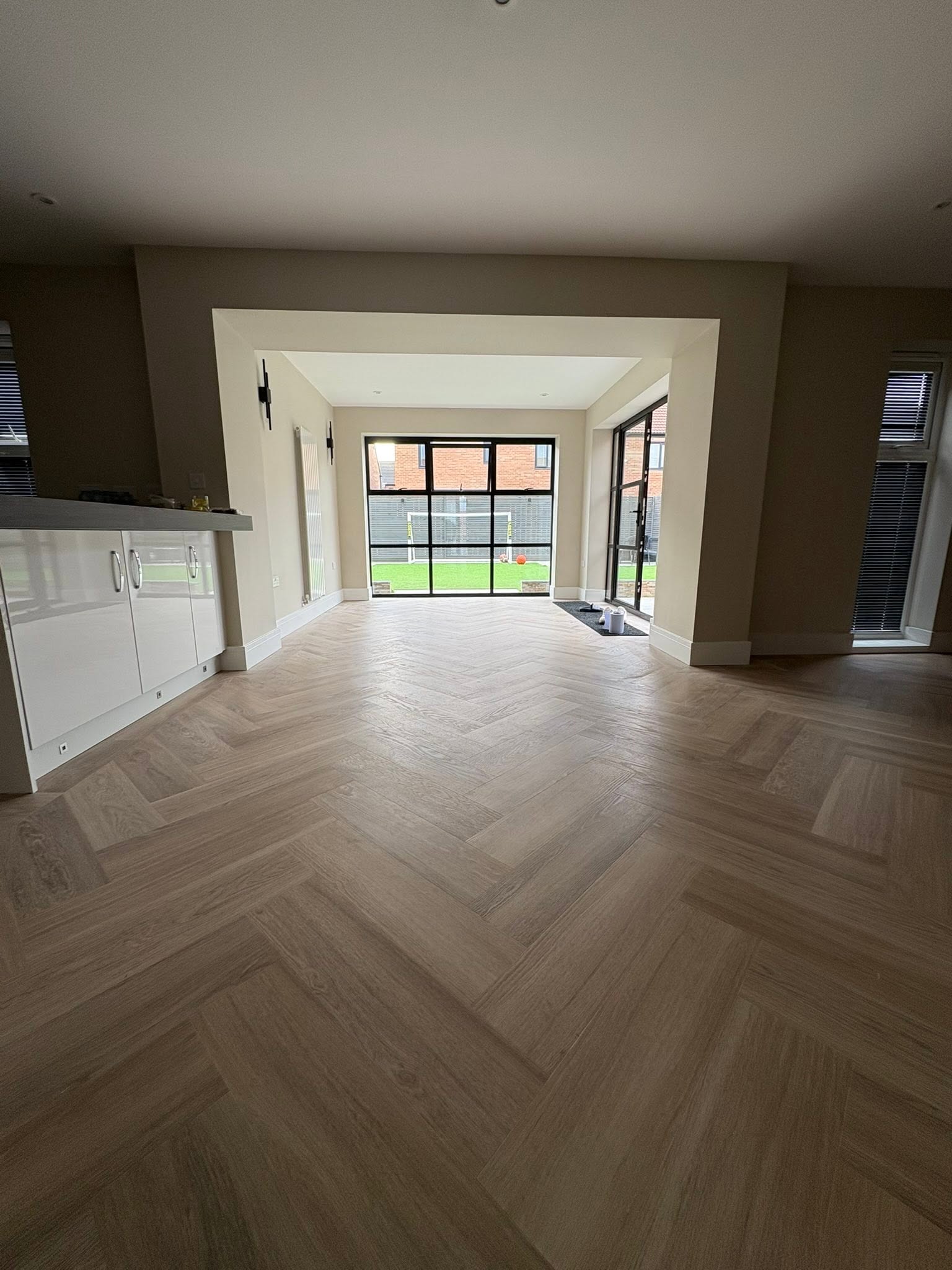 Open-plan extension with herringbone flooring and Crittall-style doors