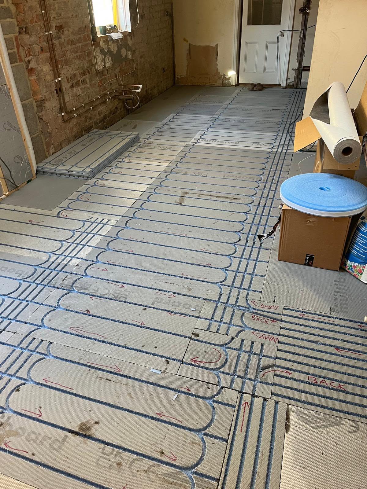 Underfloor heating being laid during the build phase